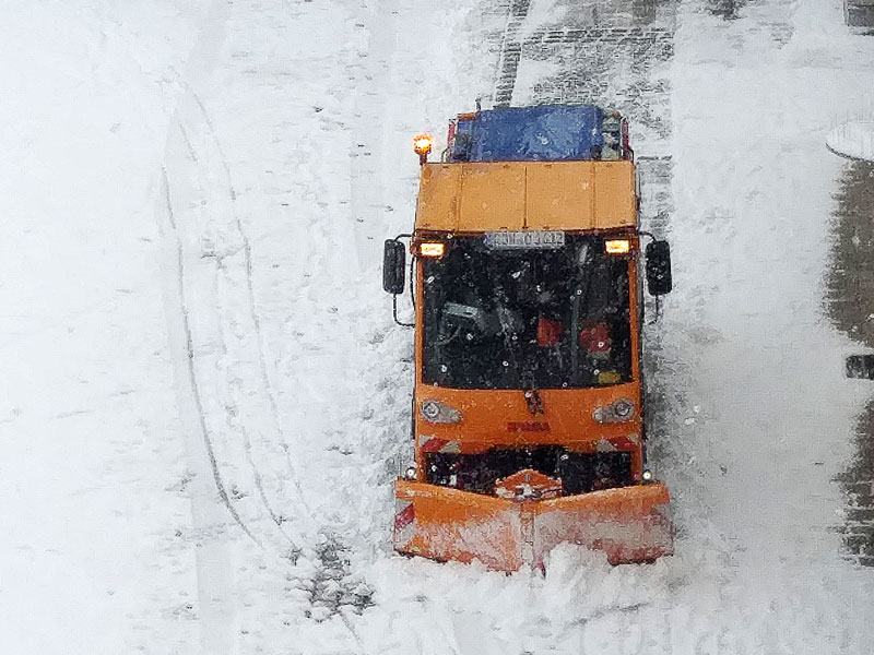 Ein Räumfahrzeug fährt über den Königsplatz in Schwabach und schiebt Schnee weg.